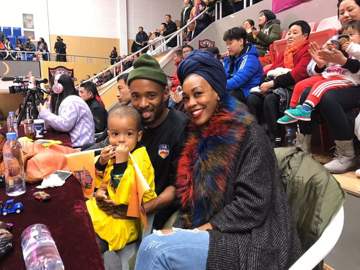 Imani Basheer attends a football game in Wuhan, China, with her husband and son. The family was forced to sell their belongin PHOTO PROVIDED BY IMANI BASHEER