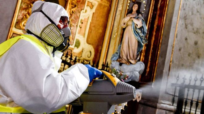 A person fumigates a church in Naples, Italy, 06 March 2020 / EPA / Churches have been fumigated in Naples