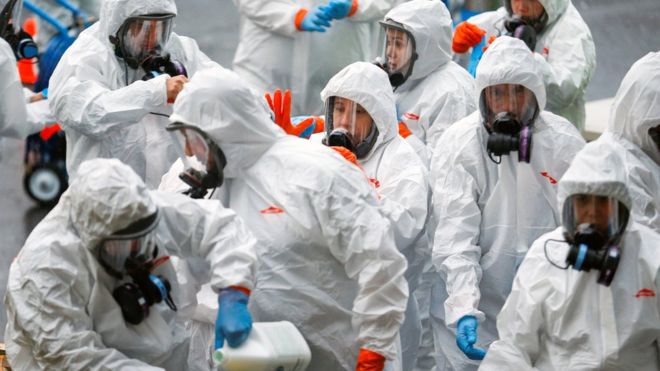 REUTERS / Workers put on protective gear before entering an infected care home in Washington state in the US