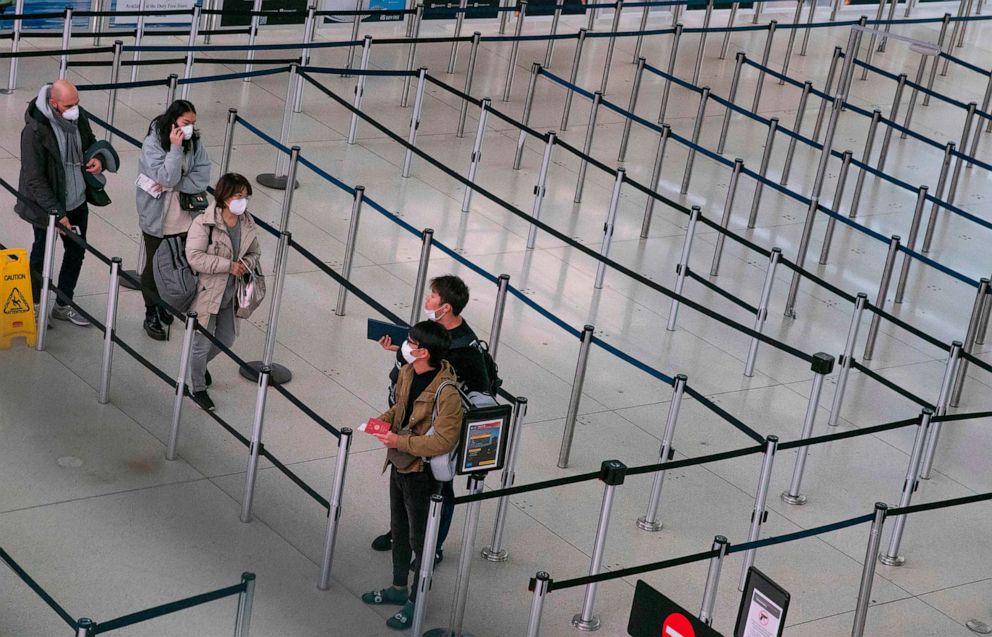 AFP via Getty Images, FILEPassengers wait at the Terminal 1 section at John F. Kennedy International Airport, March 12, 2020 in New York.Passengers wait at the Terminal 1 section at John F. Kennedy International Airport, March 12, 2020 in New York. AFP vi