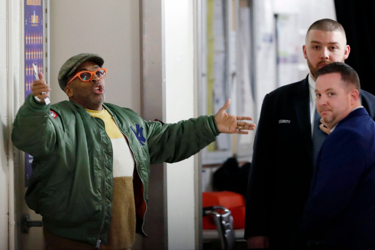 Spike Lee, left, gestures in a hallway at Madison Square Garden while arguing with security officers on March 2. PHOTO: KATHY WILLENS/ASSOCIATED PRESS