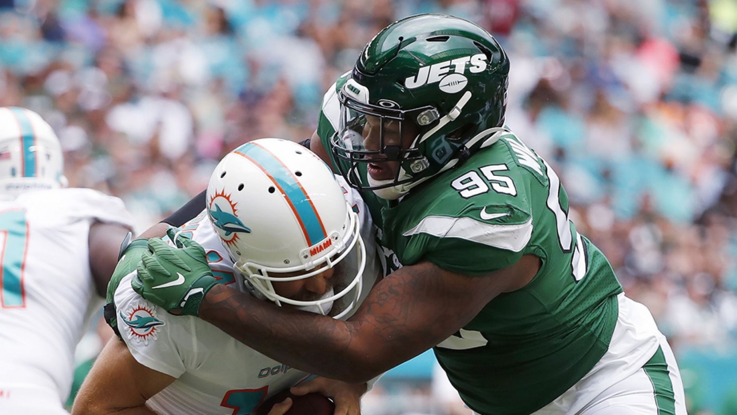 In this Nov. 3, 2019, file photo, New York Jets defensive tackle Quinnen Williams (95) sacks Miami Dolphins quarterback Ryan Fitzpatrick during the first half of an NFL football game in Miami Gardens, Fla. (AP Photo/Wilfredo Lee, File&#