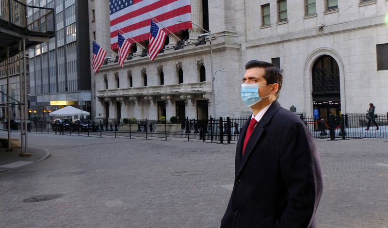 An unidentified man wears a face mask early Wednesday morning on Wall Street near the New York Stock Exchange in New York City. An unidentified man wears a face mask early Wednesday morning on Wall Street near the New York Stock Exchange in New York City.