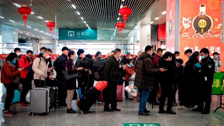 Passengers in face masks queueing to show a green QR code on their phones to security upon arrival at Wenzhou railway station in Wenzhou. Passengers in face masks queueing to show a green QR code on their phones to security upon arrival at Wenzhou railway