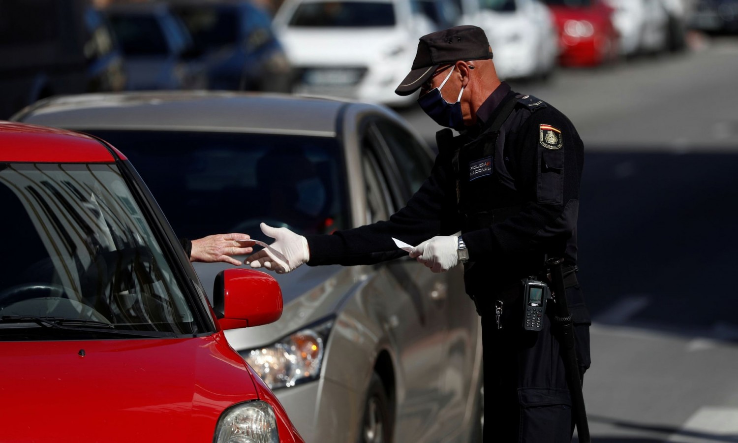 Facebook Twitter Pinterest  A police officer checks the papers of a driver in Spain. Photograph: Jon Nazca/Reuters