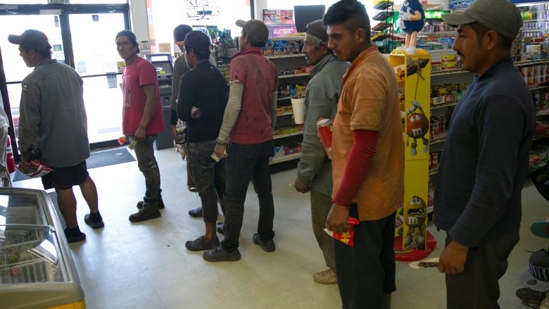 Mexican migrant workers line up to pay for snacks after harvest at an oranges farm in Lake Wales, Florida. April 1. President Donald Trump announced on Twitter Monday night that he would suspend temporarily all immigration to the United States through an