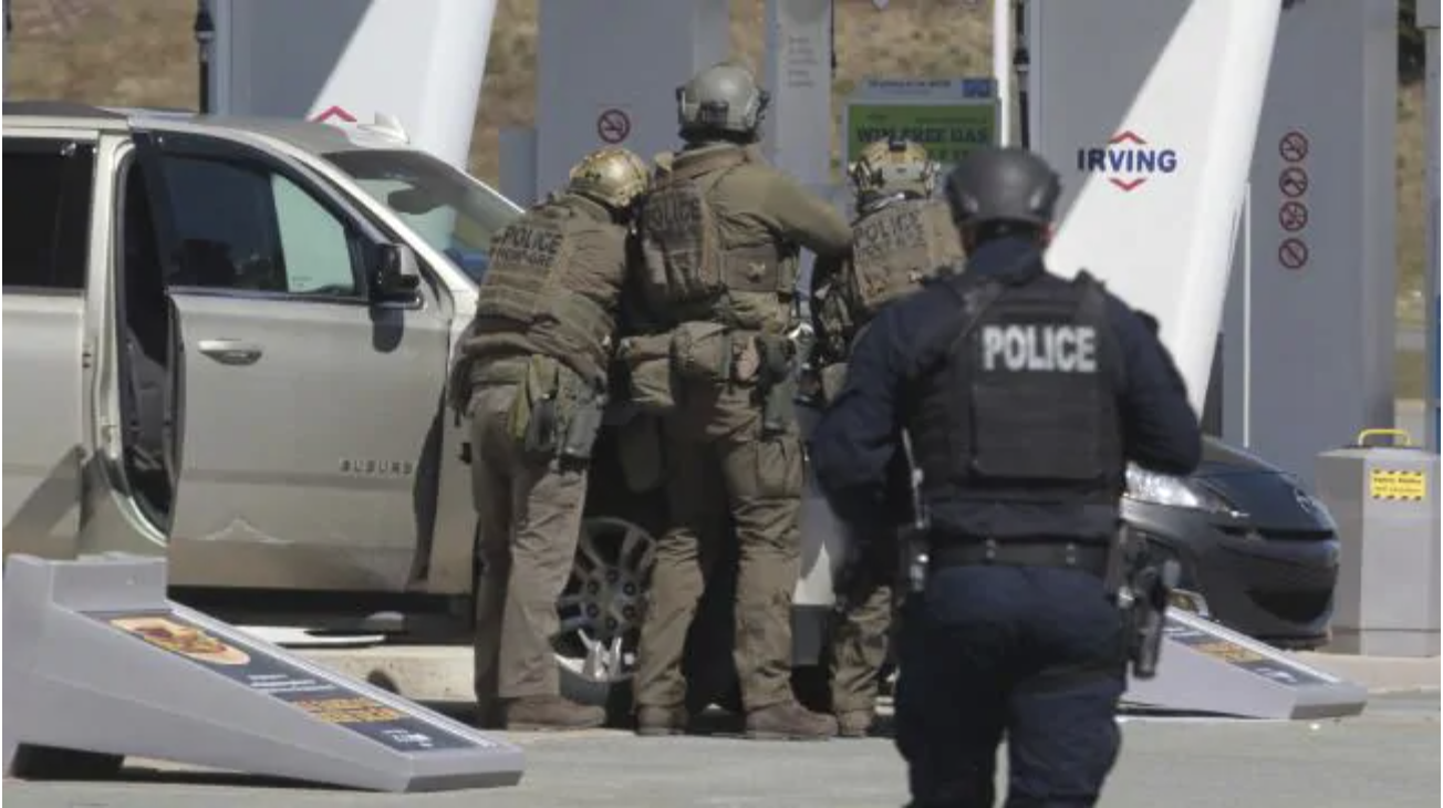 Royal Canadian Mounted Police officers take a suspect into custody at a petrol station in Enfield, Nova Scotia. Picture: Tim Krochak/The Canadian Press via APSource:AP