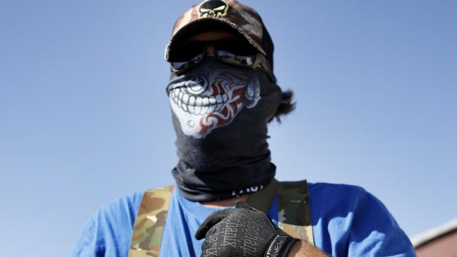 Armed protester Wyatt Winn waits for Ector County Sheriff's officers and Texas State Troopers.Source:AP