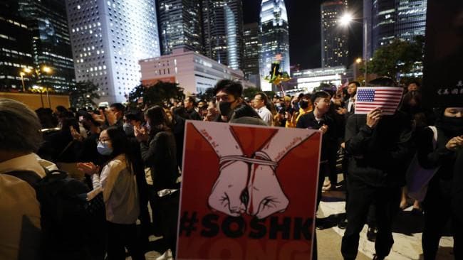 A protestor holds a placard showing bound hands during a demonstration in Hong Kong. Picture: AP/Vincent ThianSource:NewsComAu