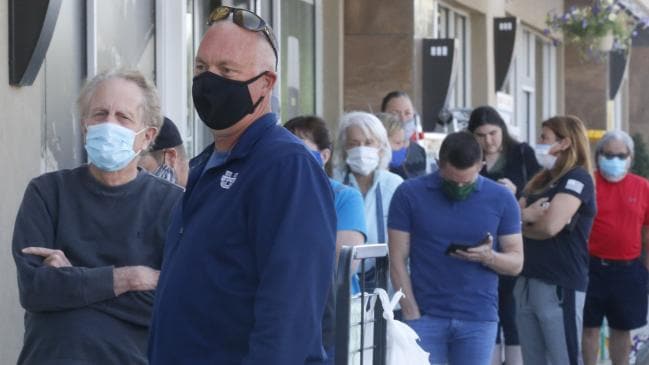 People line up to enter a meat works in the US.Source:AP