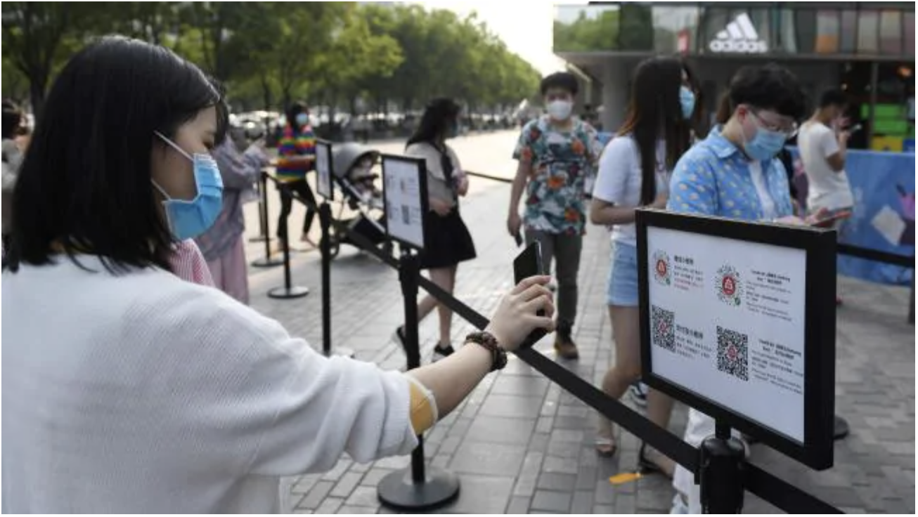 A woman scans a phone code required to prove her health and travel status before being allowed to enter a shopping mall in Beijing. Picture: Greg Baker/AFP A woman scans a phone code required to prove her health and travel status before being allowed to enter a shopping mall in Beijing. Picture: Greg Baker/AFPSource:AFP