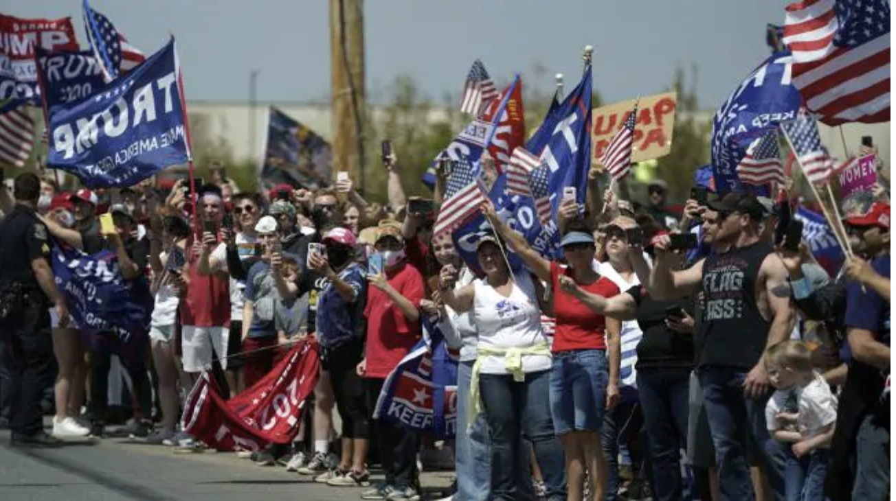 A crowd of supporters looking on as Mr Trump’s motorcade passed yesterday. Great social distancing there, guys. Picture: Evan Vucci/APSource:AP