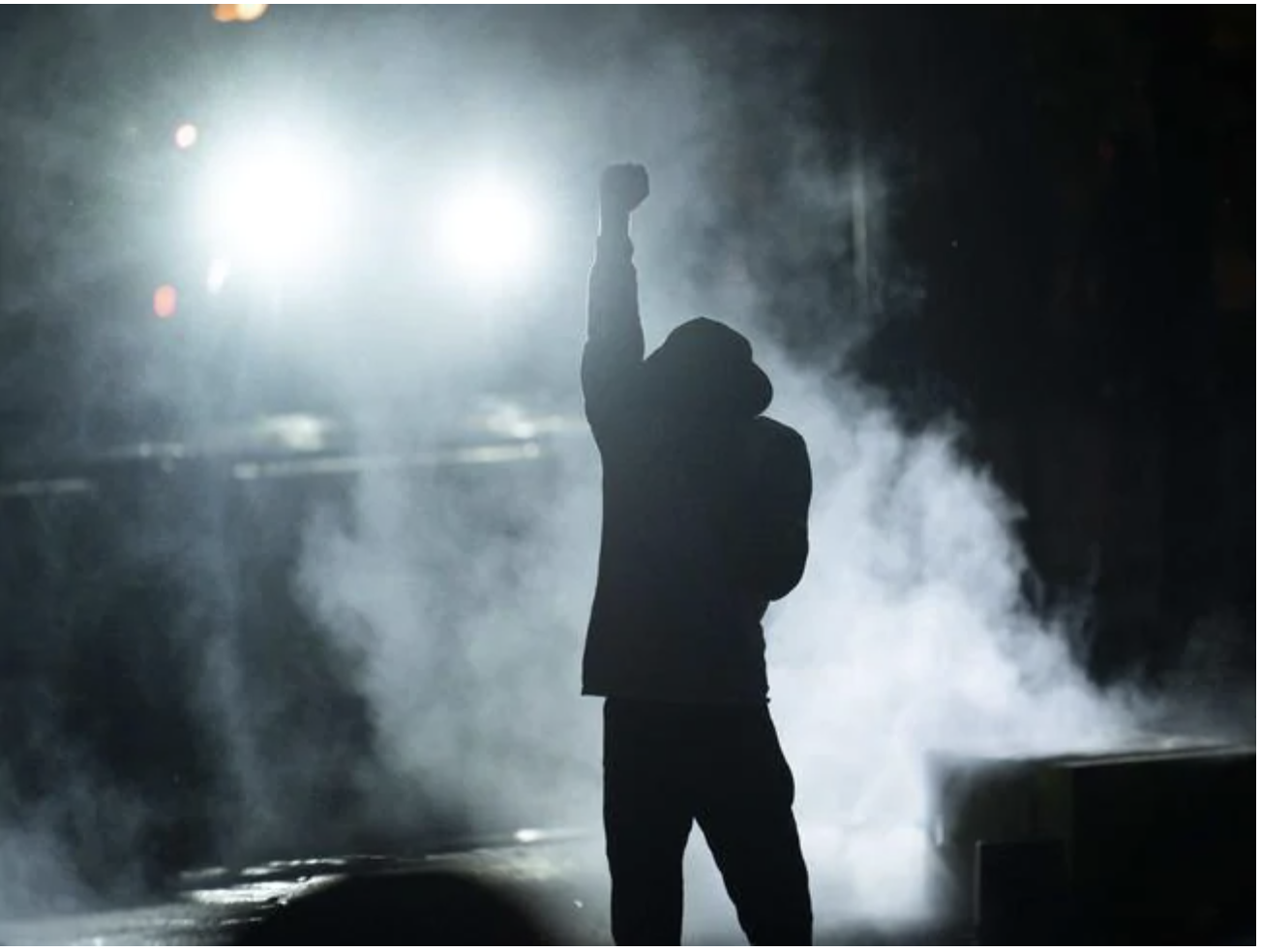 A protester holds up a fist in a cloud of tear gas outside the Third Police Precinct building in Minneapolis, Minnesota. Picture: Stephen Maturen/Getty Images/AFP A protester holds up a fist in a cloud of tear gas outside the Third Police Precinct building in Minneapolis, Minnesota. Picture: Stephen Maturen/Getty Images/AFPSource:AFP