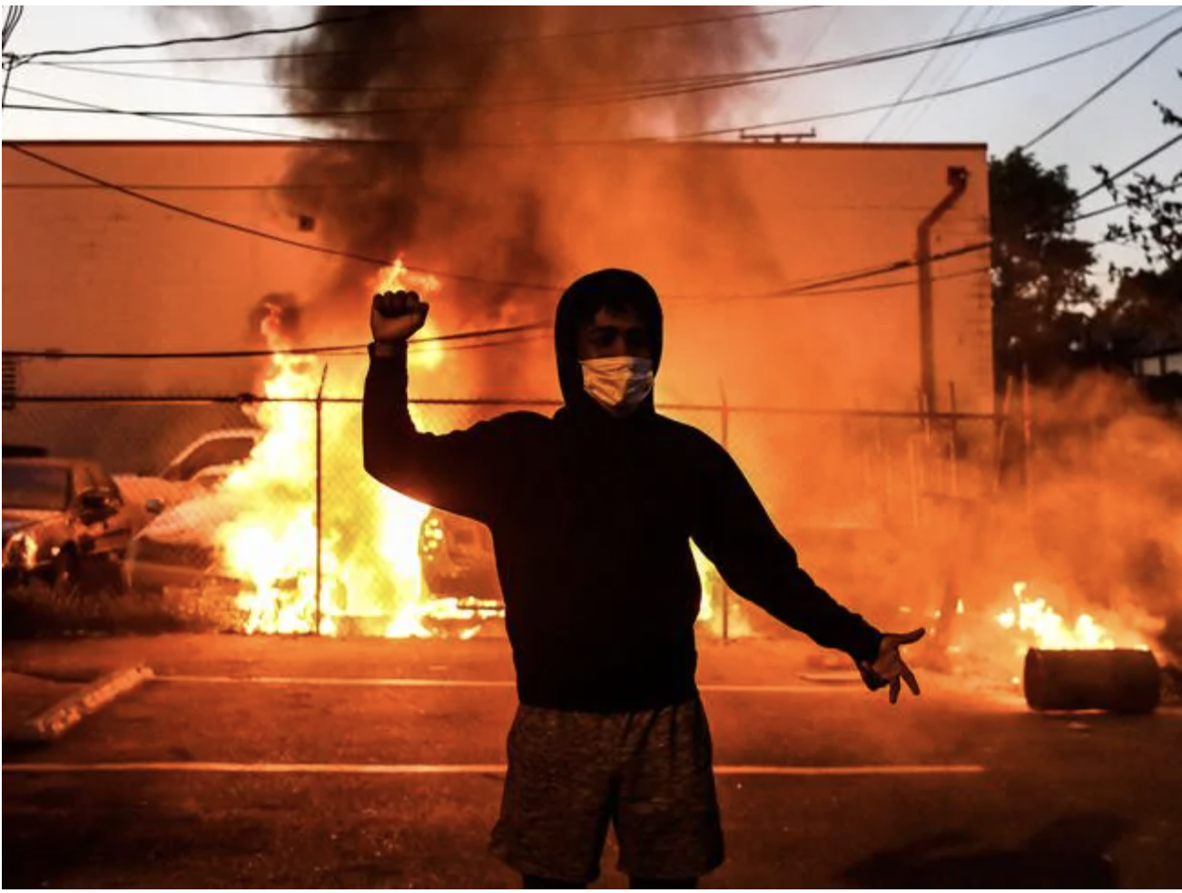 A protester gestures as cars burn behind him during a demonstration in Minneapolis, Minnesota, on May 29 over the death of George Floyd. Picture: Chandan KhannaSource:AFP