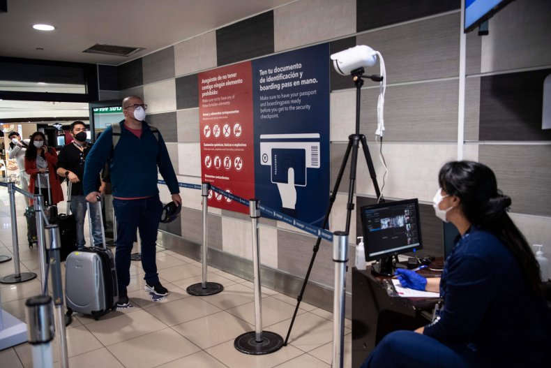 A Chile's Health Ministry worker monitors a screen of a thermal scanner to check body temperature of a passenger before boarding a flight at Santiago International Airport, in Santiago, on April 20, 2020MARTIN BERNETTI/AFP/GETTY