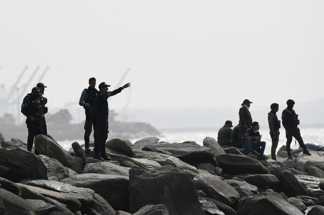 Security forces guard the shore where authorities claim a group of armed men landed in the port city of La Guaira, Venezuela Security forces guard the shore where authorities claim a group of armed men landed in the port city of La Guaira, Venezuela