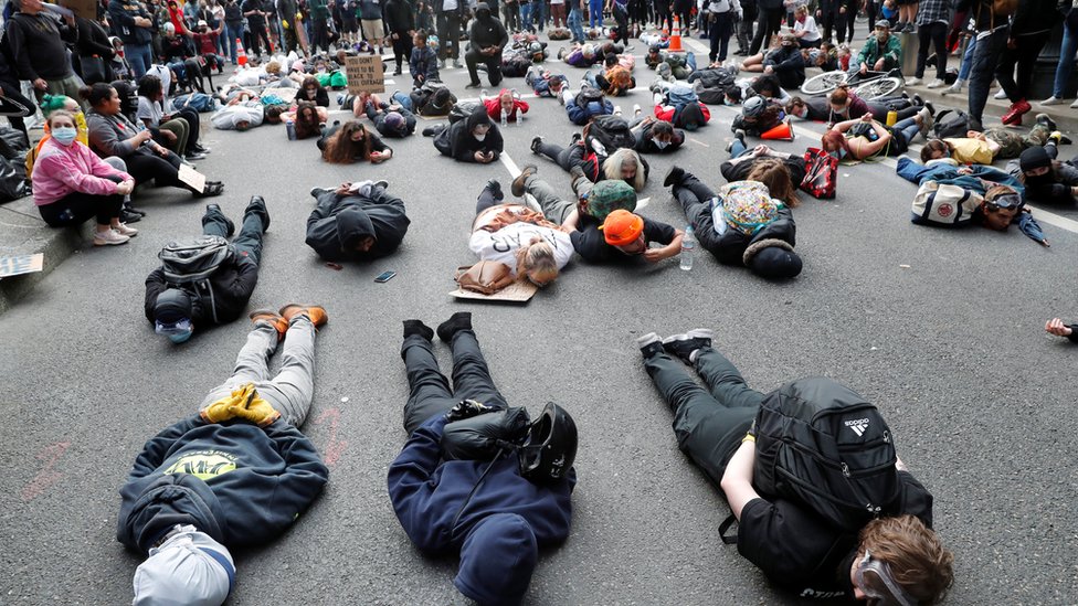 Protesters lie on the streets in Portland, Oregon / REUTERS