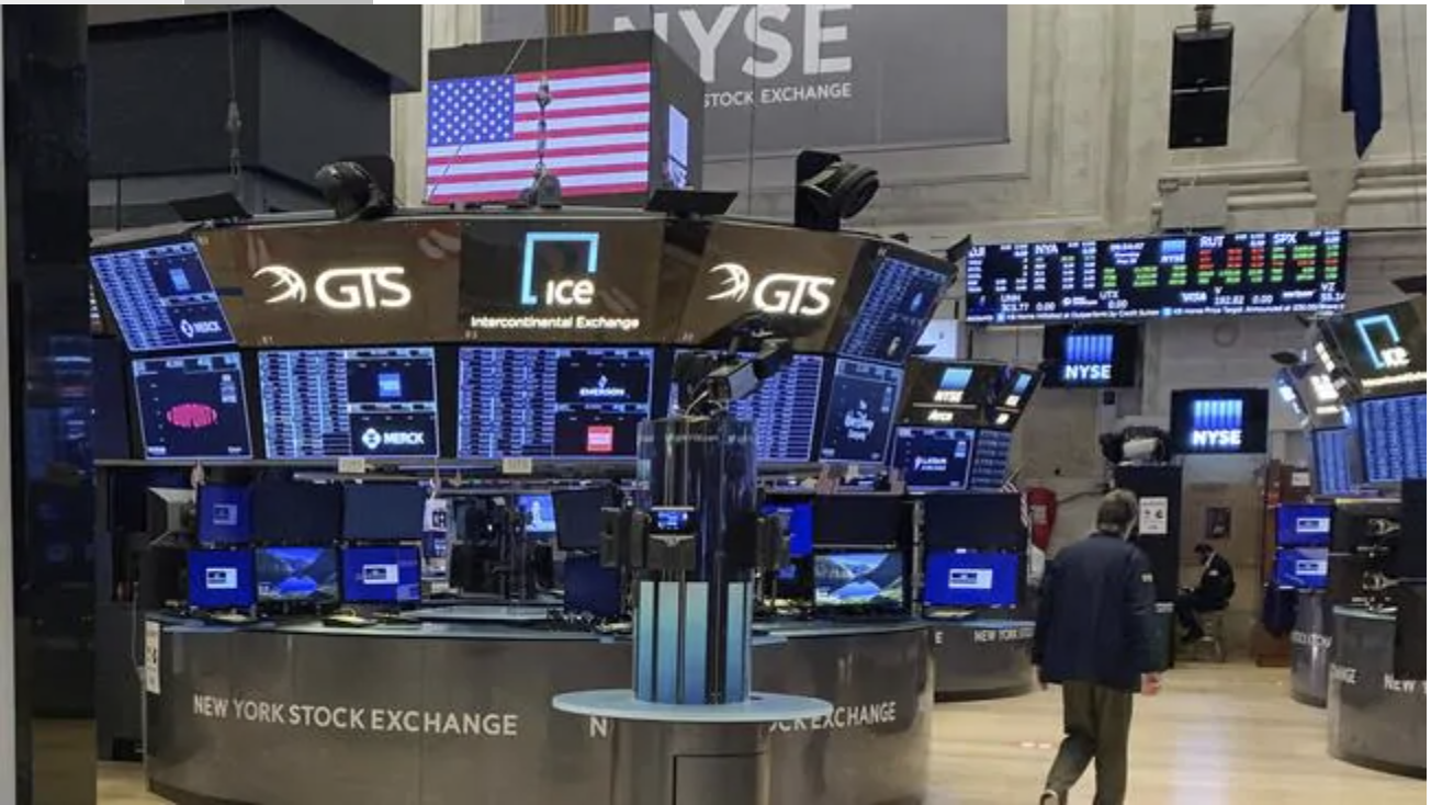 A trader walks across the partially reopened trading floor of the New York Stock Exchange last month. Picture: APSource:AP