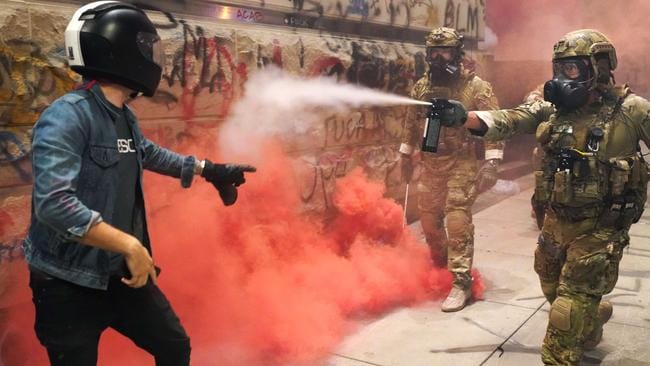 A federal officer pepper sprays a protester in Portland, Oregon. Picture: Nathan Howard/Getty Images/AFPSource:AFP