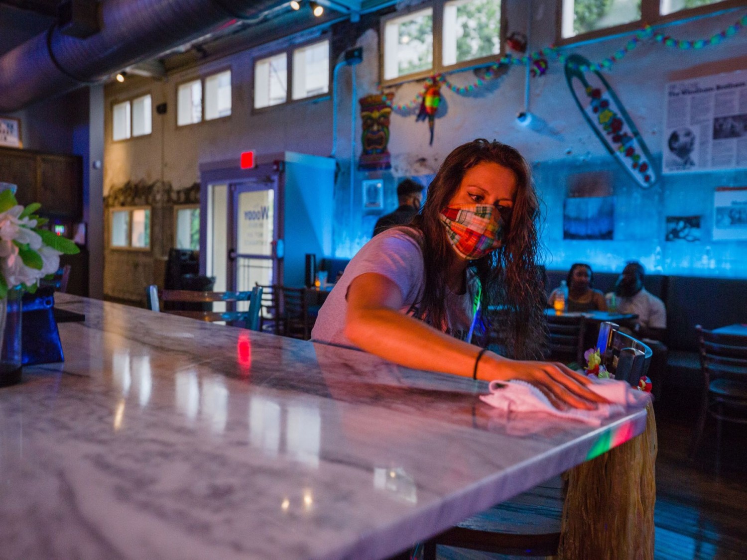 A worker disinfects a bar at a nightclub in Columbia, South Carolina. Photographer: Micah Green/Bloomberg