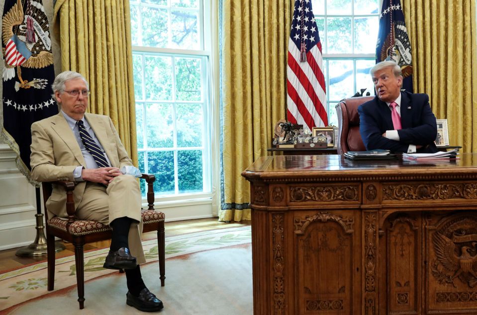 U.S. President Donald Trump speaks about legislation for additional coronavirus aid as U.S. Senate Majority Leader Mitch McConnell (R-KY) listens in the Oval Office at the White House in Washington, U.S., July 20, 2020. REUTERS/Leah Millis