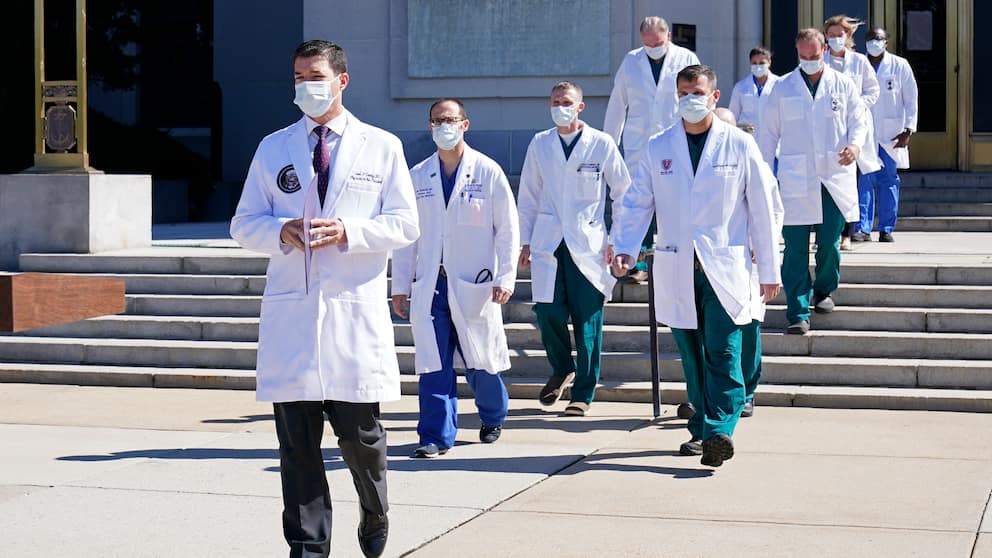 White House physicial Sean P. Conley leads a team of medical professionals to a news briefing Saturday at Walter Reed National Military Medical Center in Bethesda, Md. (AP)