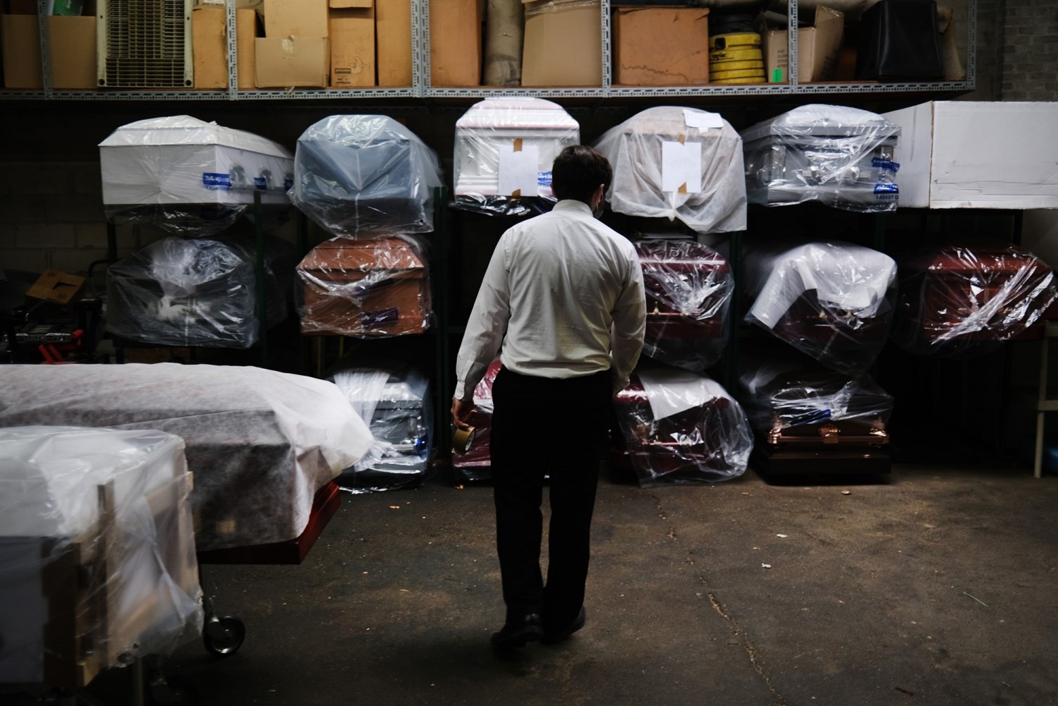 James Harvey tends to the inventory of pre-sold caskets at a funeral home in New York City in April.Spencer Platt / Getty Images file