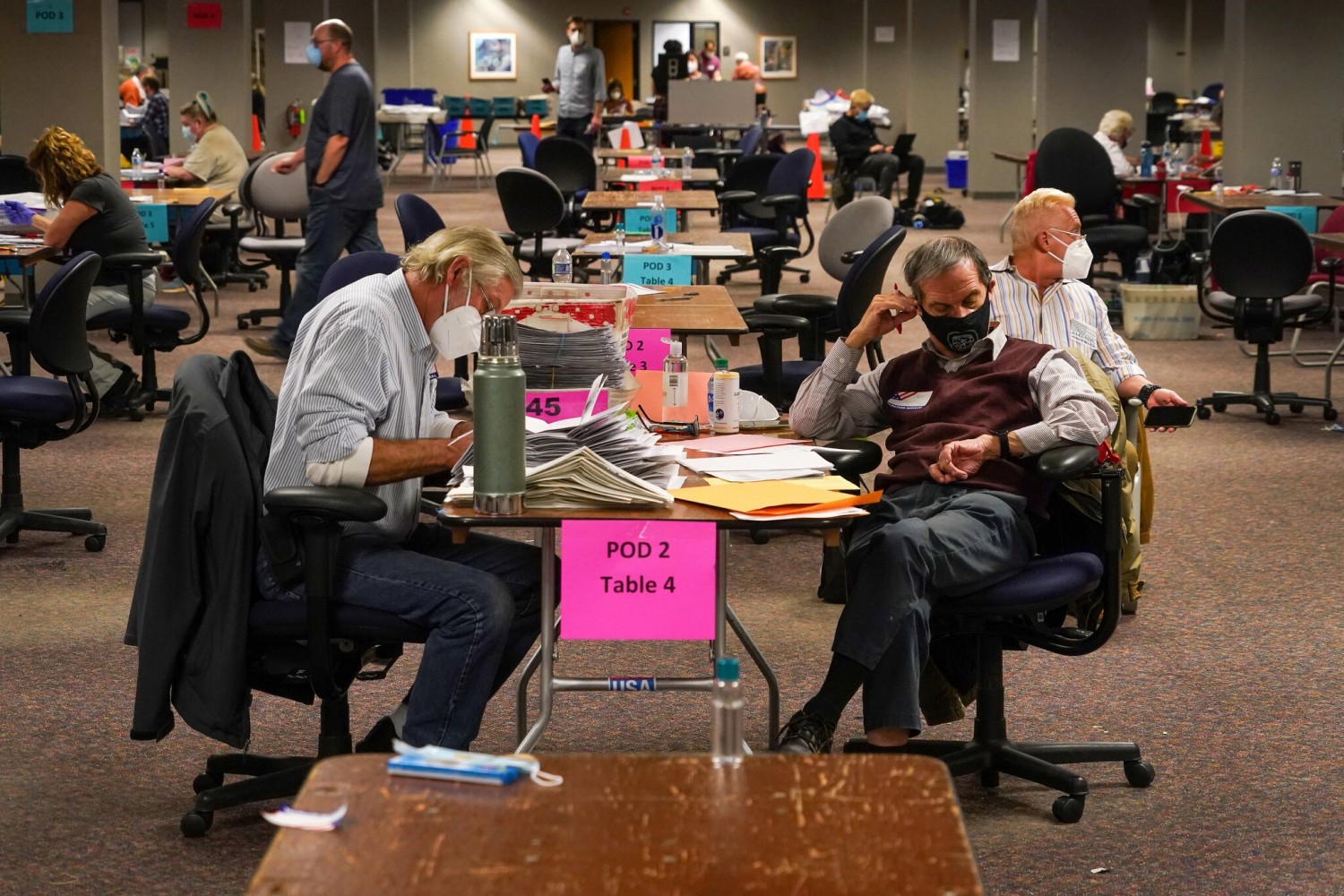Workers counting votes in Milwaukee on Tuesday. Mr. Biden is running well ahead of Hillary Clinton’s 2016 margins in the Wisconsin counties of Waukesha and Dane.Credit...Chang W. Lee/The New York Times