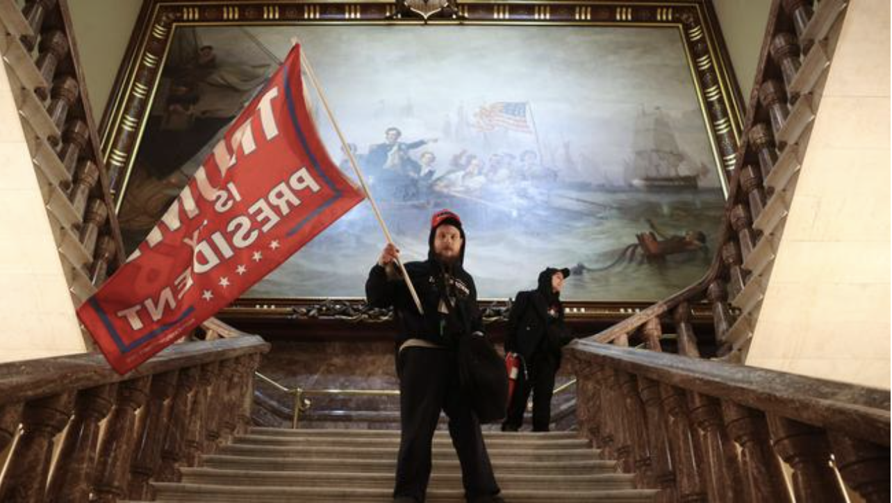 A protester holds a Trump flag inside the US Capitol Building. Picture: Win McNamee/Getty Images/AFPSource:AFP