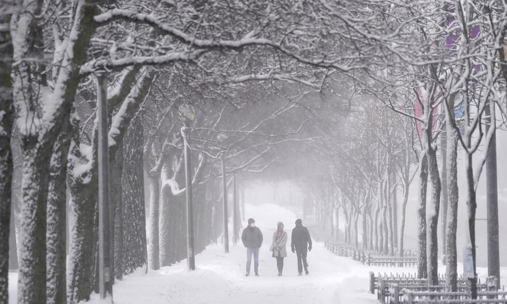Pedestrians stroll down a snow-covered sidewalk Sunday in Chicago’s Grant Park. Photograph: Charles Rex Arbogast/AP