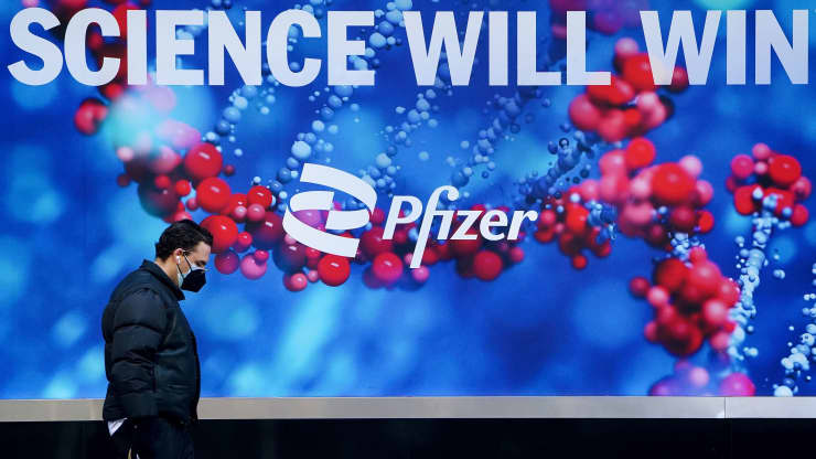 A person walks past the Pfizer building in New York City, March 2, 2021. Carlo Allegri | Reuters