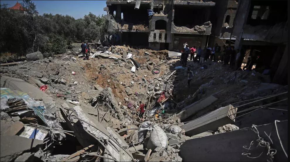 Palestinians inspect the damage of a house that was destroyed by an Israeli airstrike in town of Khan Younis, Gaza Strip, May 19, 2021.