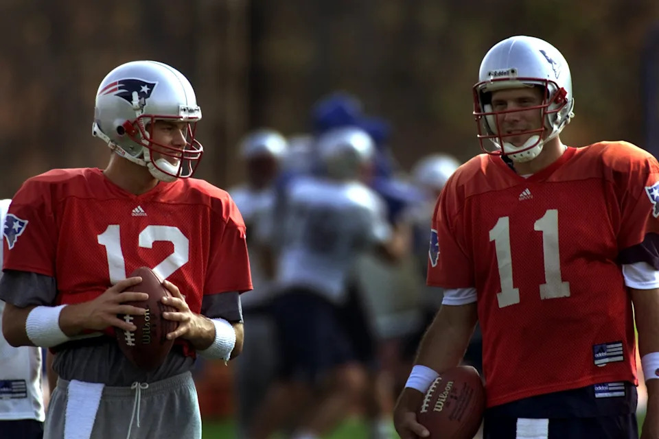 The Patriots drafted Tom Brady (left) despite having three quarterbacks on the roster, including Drew Bledsoe (right). (Photo by Barry Chin/The Boston Globe via Getty Images)