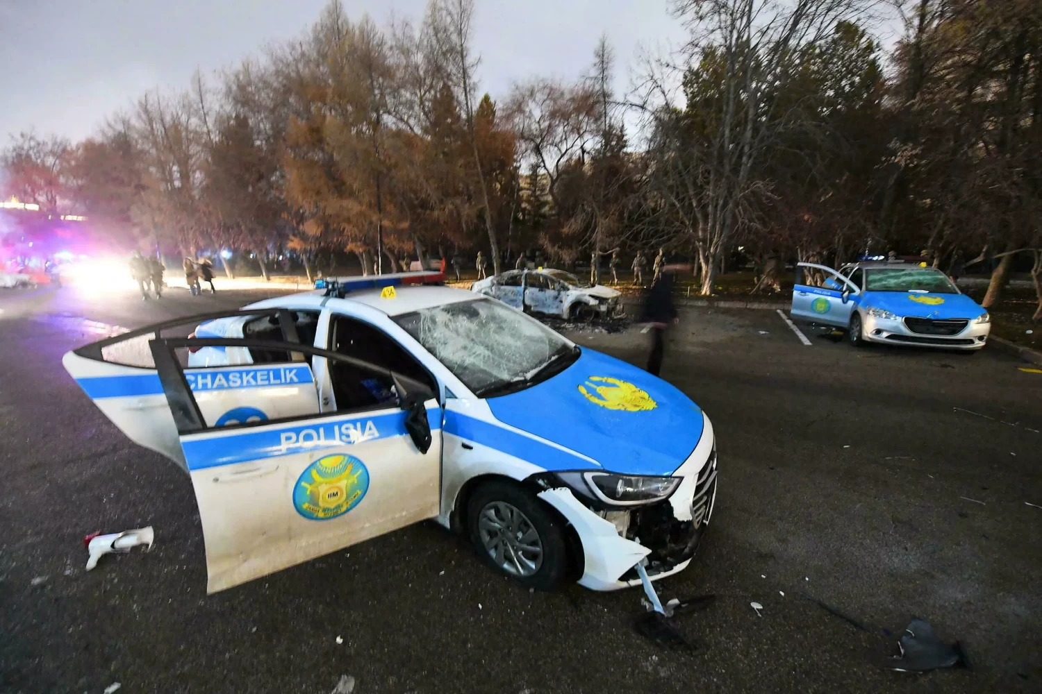 Damaged police cars pictured near the mayor's office in Almaty on January 5, 2022. © REUTERS stringer