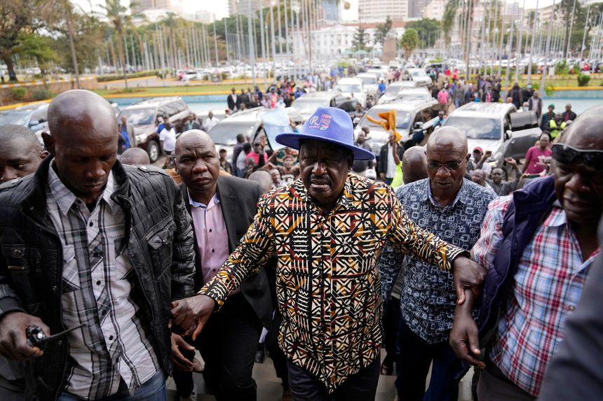 Kenyan presidential candidate Raila Odinga, in a blue hat, arrived at his campaign headquarters in Nairobi, Kenya. PHOTO: BEN CURTIS/ASSOCIATED PRESS