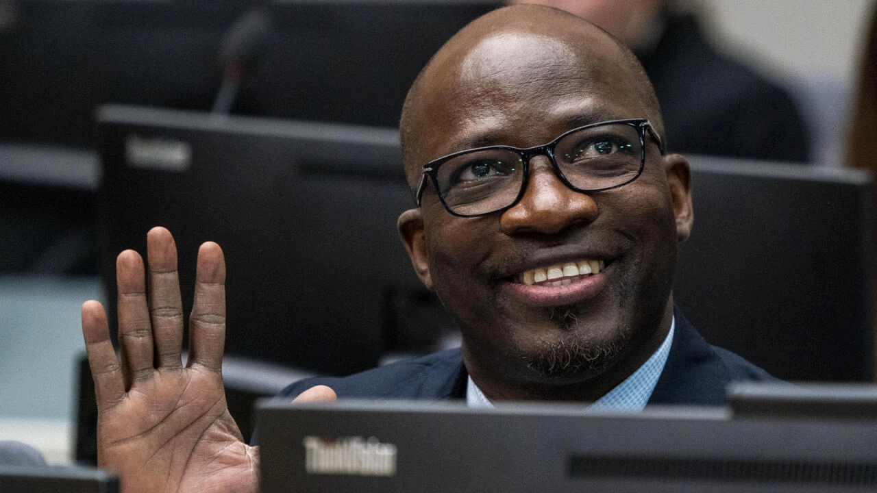 Ivory Coast politician and businessman Charles Ble Goude waves to supporters attending the appeals hearing at the International Criminal Court in The Hague, Netherlands, February 6, 2020. © Jerry Lampen, AP
