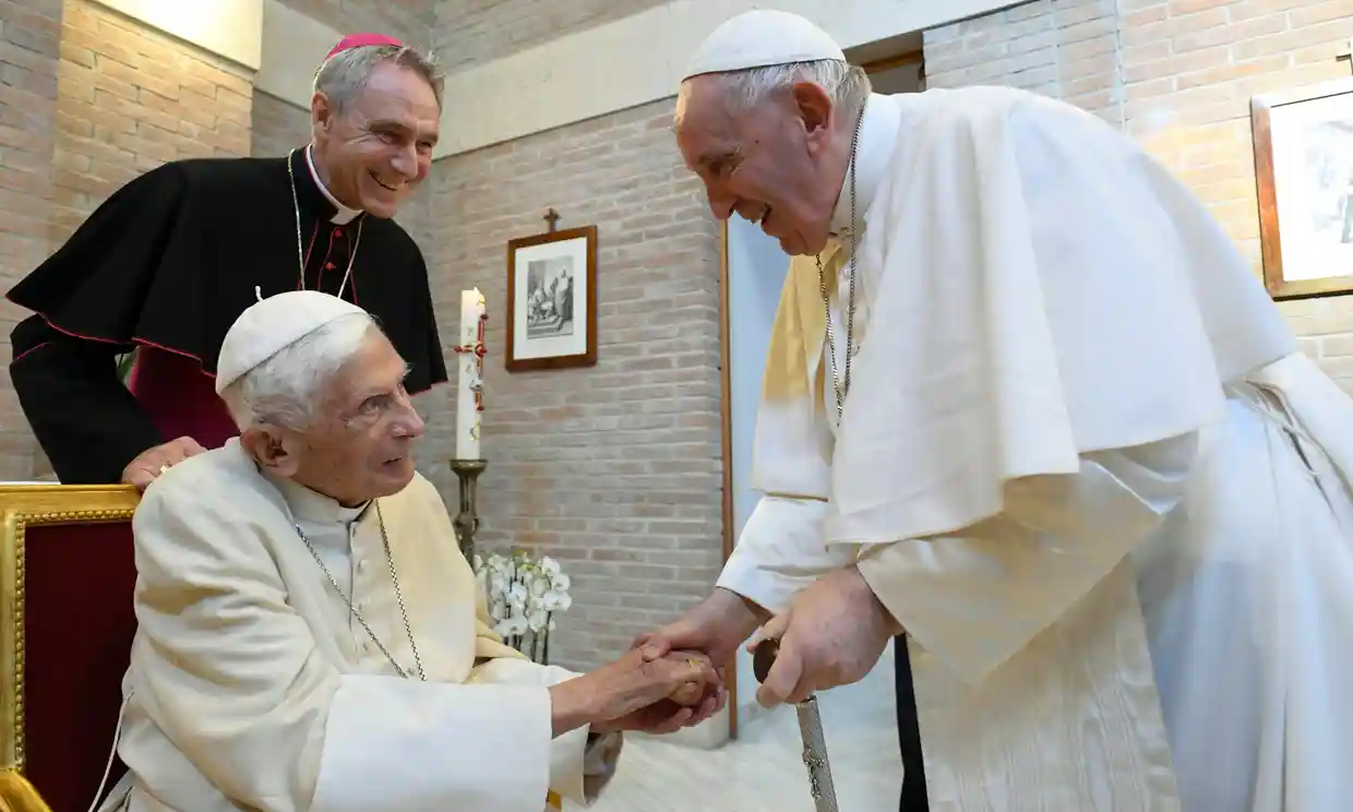 Pope Francis, right, shakes hands with Pope Emeritus Benedict XVI in the Vatican in August. Photograph: Vatican Media/EPA