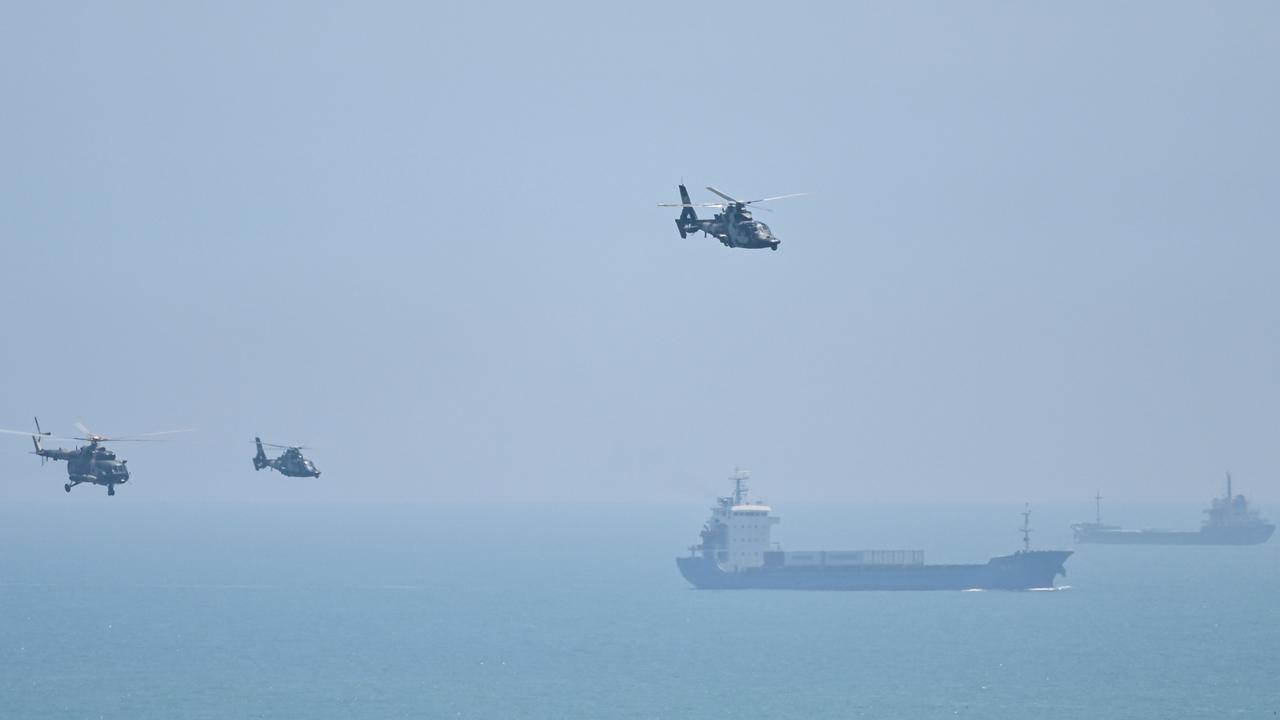 Chinese military helicopters fly past Pingtan island, one of mainland China's closest point from Taiwan in August 2022. Picture Hector RETAMAL / AFP.