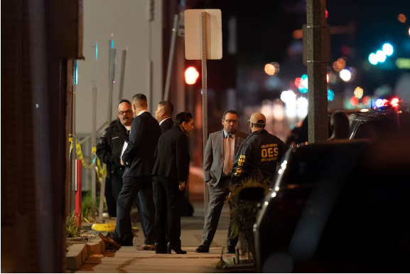 Investigators gather at the scene. (Jae C. Hong/AP)