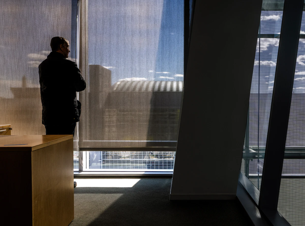 Anthony Lanier looks out the window of his office tower on Pennsylvania Avenue NW in D.C. as his only tenant prepares to relocate. (Bill O'Leary/The Washington Post)