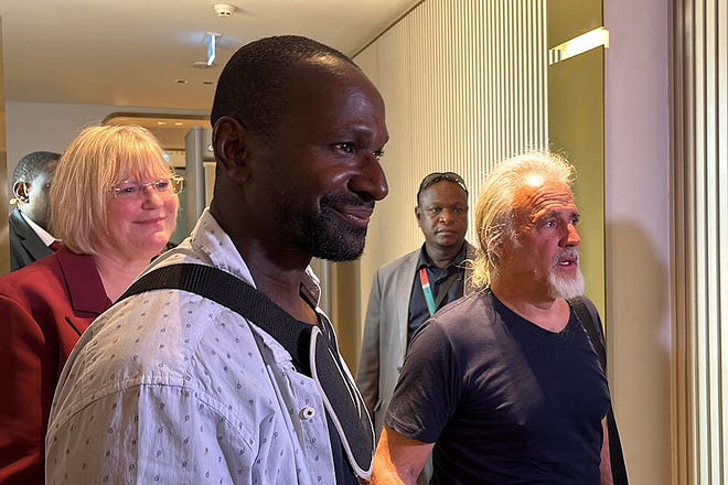 French journalist Olivier Dubois, freed nearly two years after he was kidnapped in Mali, and American Jeffery Woodke, released after being kidnapped in October 2016 in Niger, arrive at the Diori Hamani International Airport in Niamey, Niger.