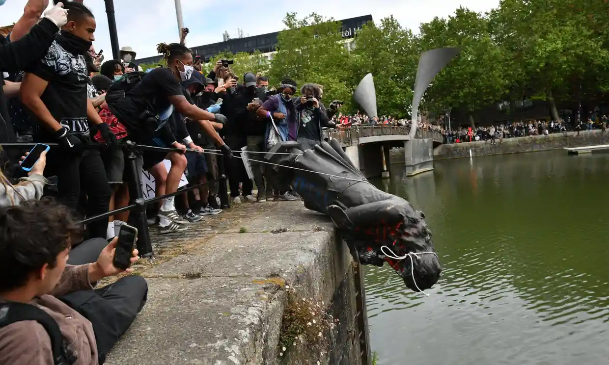 Protesters throwing the statue of Edward Colston into Bristol harbour. Photograph: Ben Birchall/PA