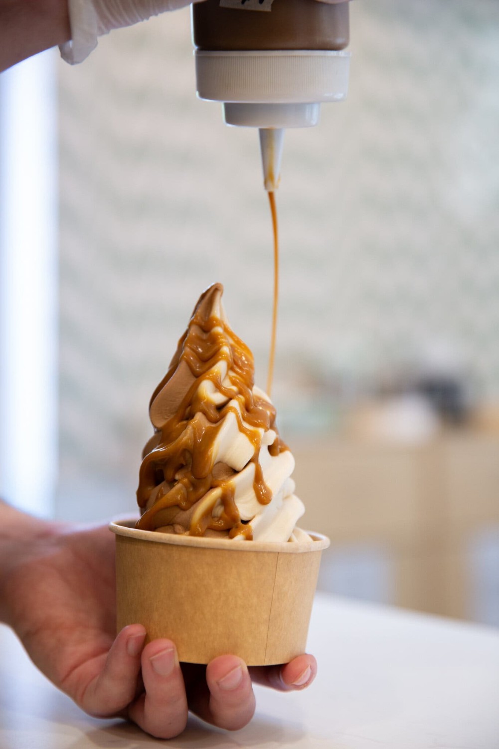 Plant-based ice cream shops are popping up across the country. Here’s the chocolate and vanilla soft serve with miso caramel at Vaca’s Creamery, in Chicago. Credit...Anjali Pinto for The New York Times