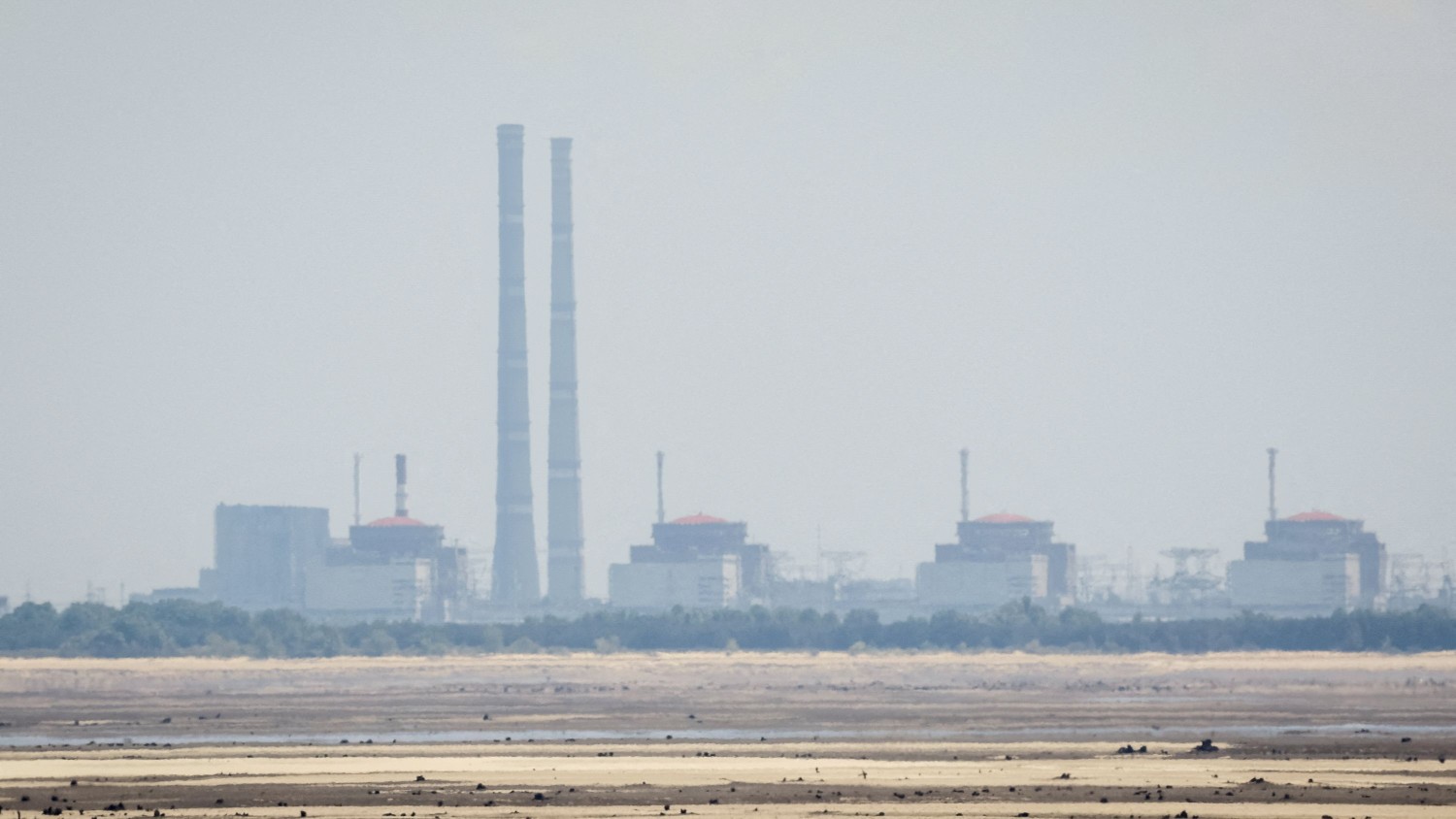 Alina Smutko/Reuters | The Zaporizhzhia plant seen from the banks of the Dnipro on June 16, after the Nova Kakhovka dam collapse.