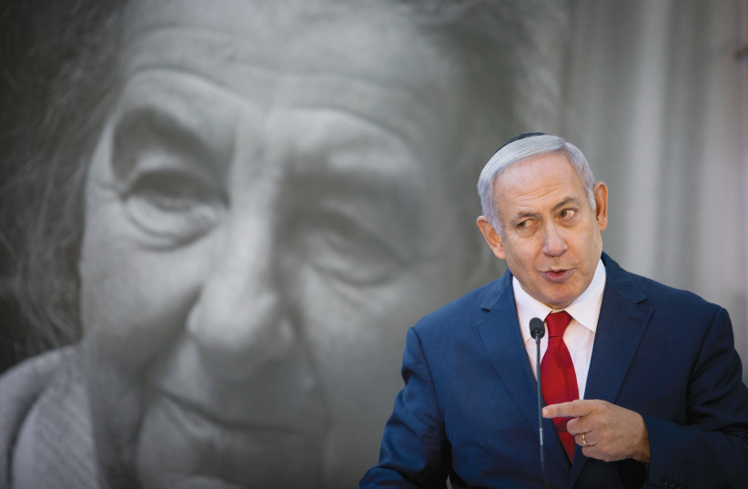 Prime Minister Benjamin Netanyahu gives a speech with the visage of Golda Meir in the background.) (photo credit: NOAM REVKIN FENTON/FLASH90)