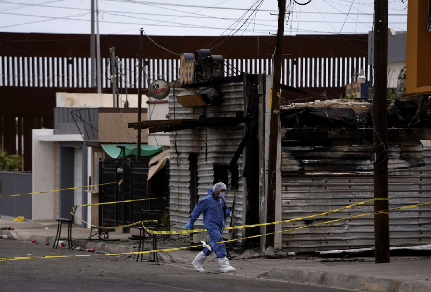A forensic technician at the scene of a deadly bar fire in San Luis Río Colorado, Mexico, on Saturday. (Victor Medina/Reuters)