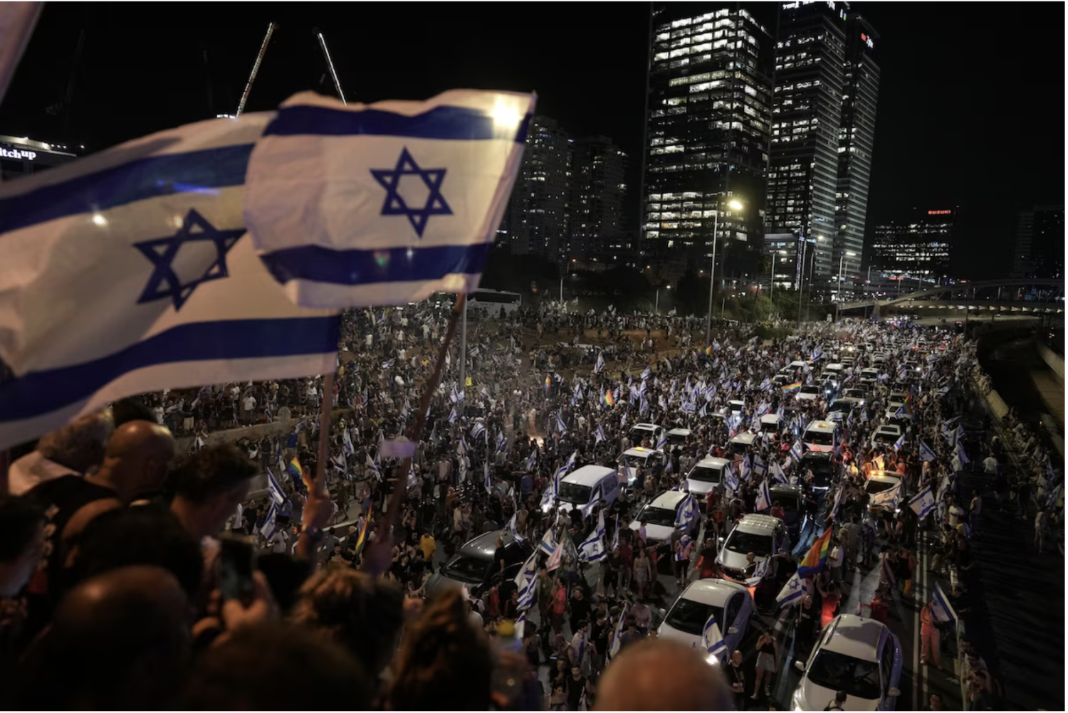 Protesters block the traffic on a highway crossing Tel Aviv on Monday. (Oded Balilty/AP)