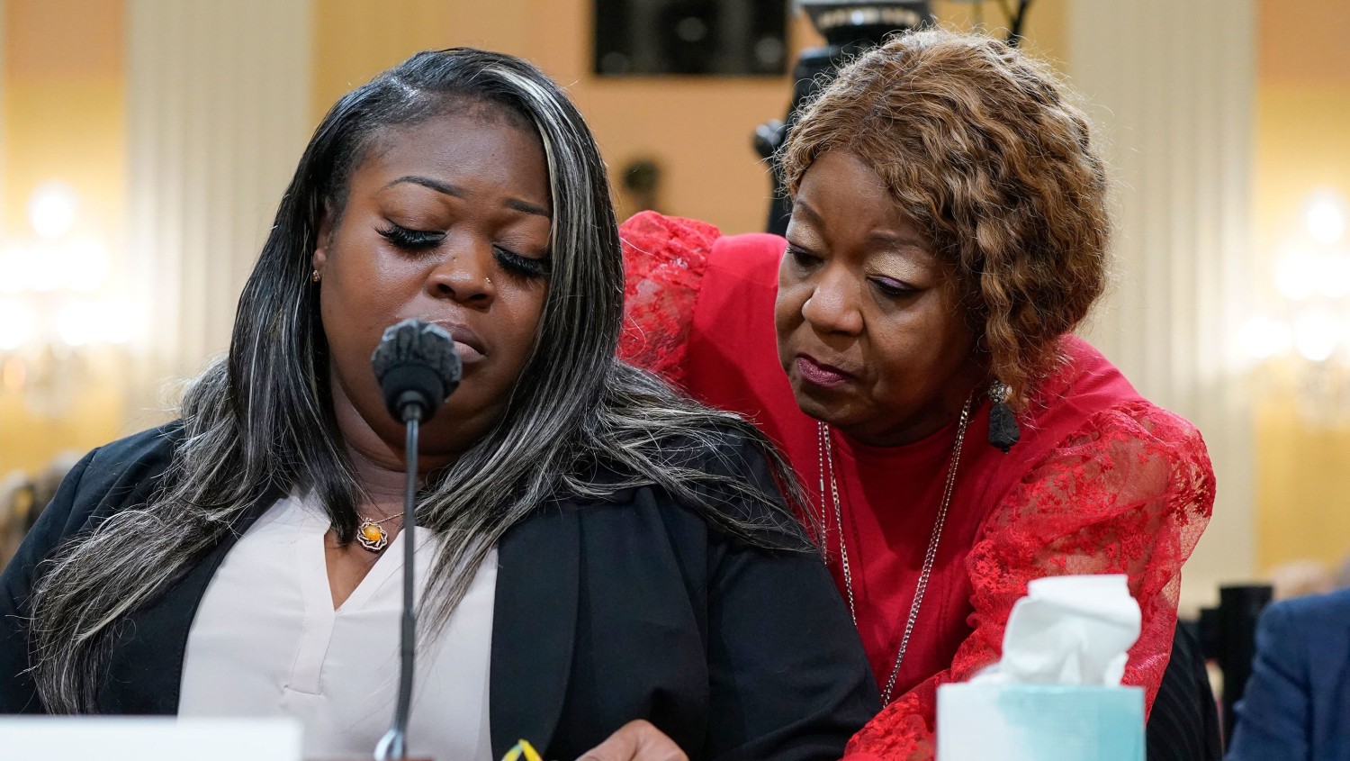 Wandrea Shaye Moss, a former Georgia election worker, is comforted by her mother, Ruby Freeman, right, as the House select committee investigating the January 6 attack on the US Capitol holds a hearing at the Capitol in Washington in June 2022.