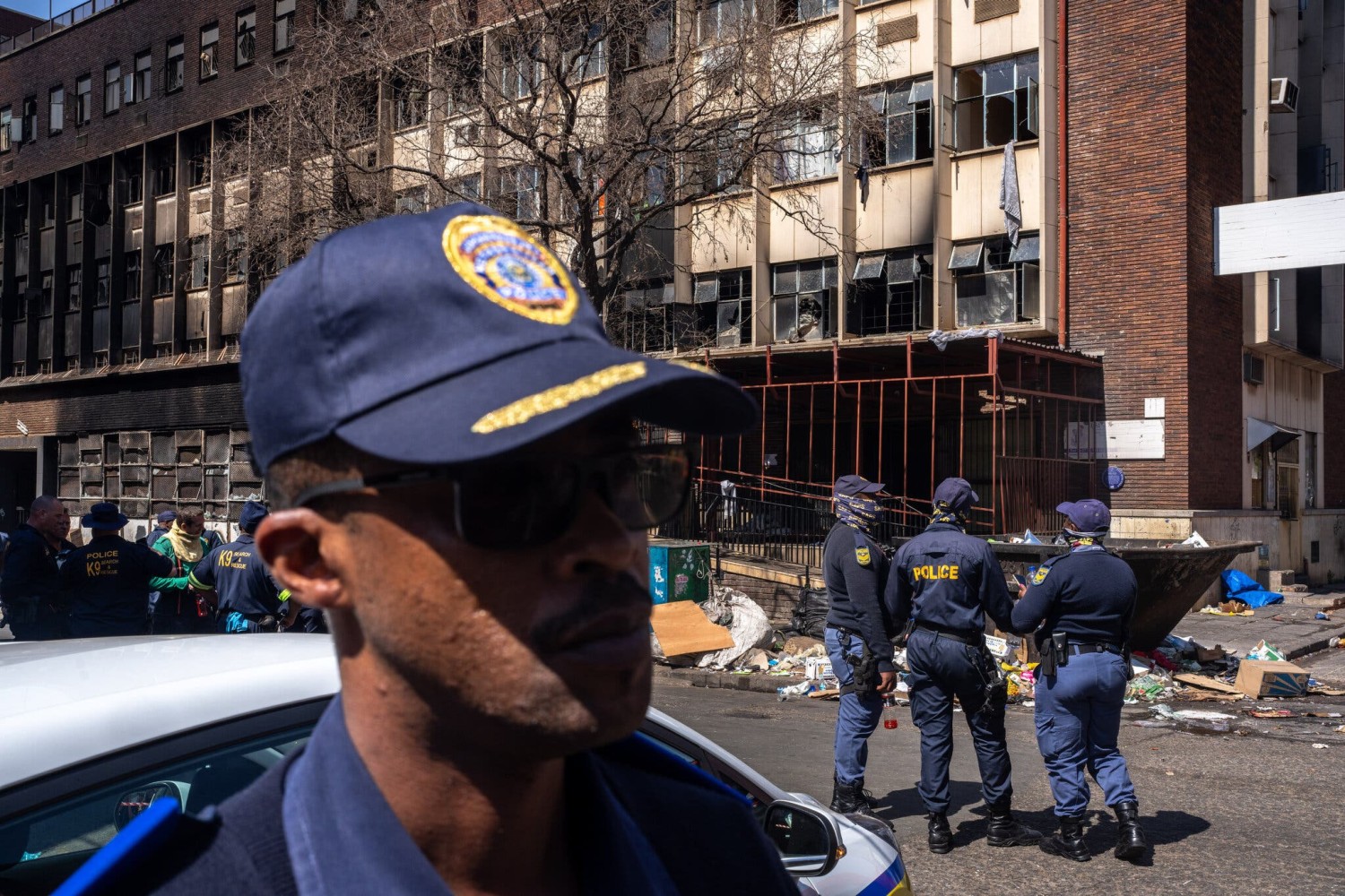 Outside the building in Johannesburg on Thursday. At least 12 children were among the victims.Credit...Joao Silva/The New York Times