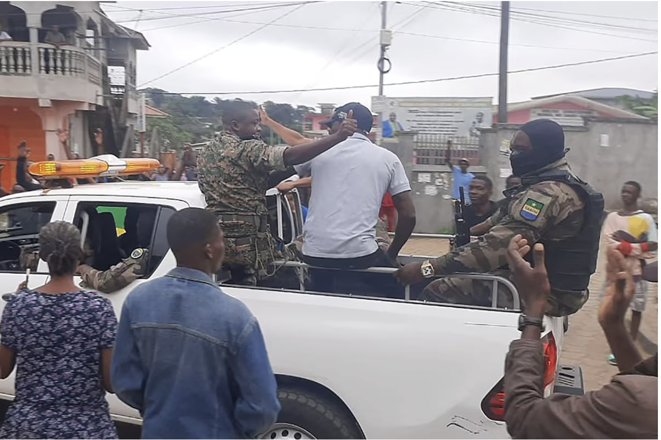 Residents applaud in Libreville, Gabon, on Wednesday after military officers appeared on television to announce they were taking over. (AFP/Getty Images)